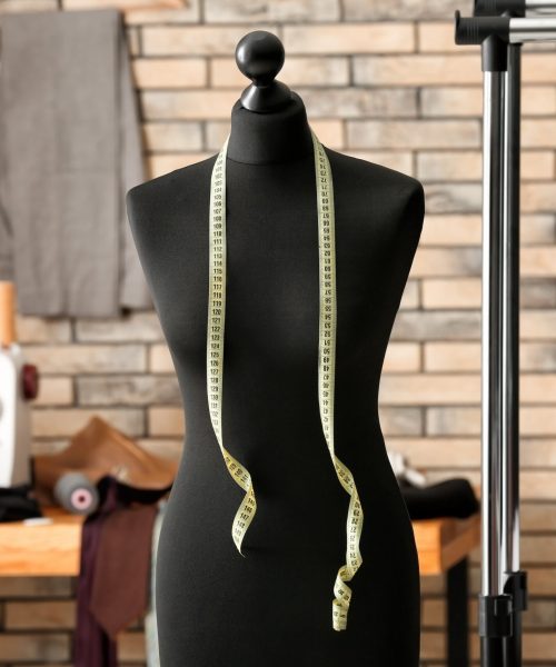 Tailor’s mannequin with measuring tape in atelier Tailor's mannequin with measuring tape in atelier